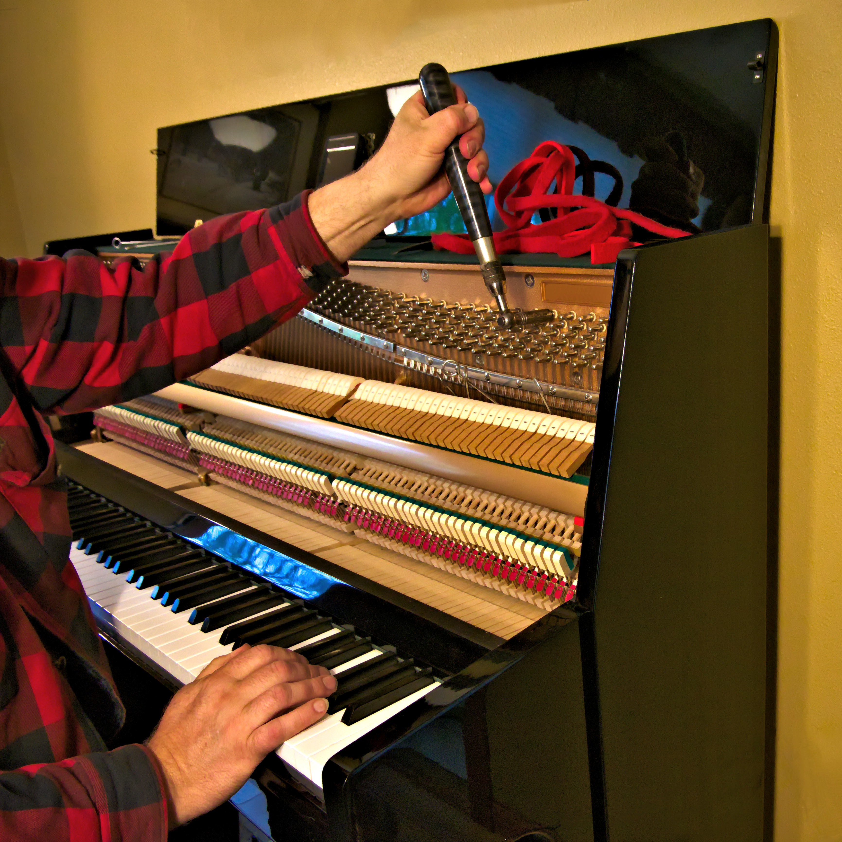photo of piano tuner at work